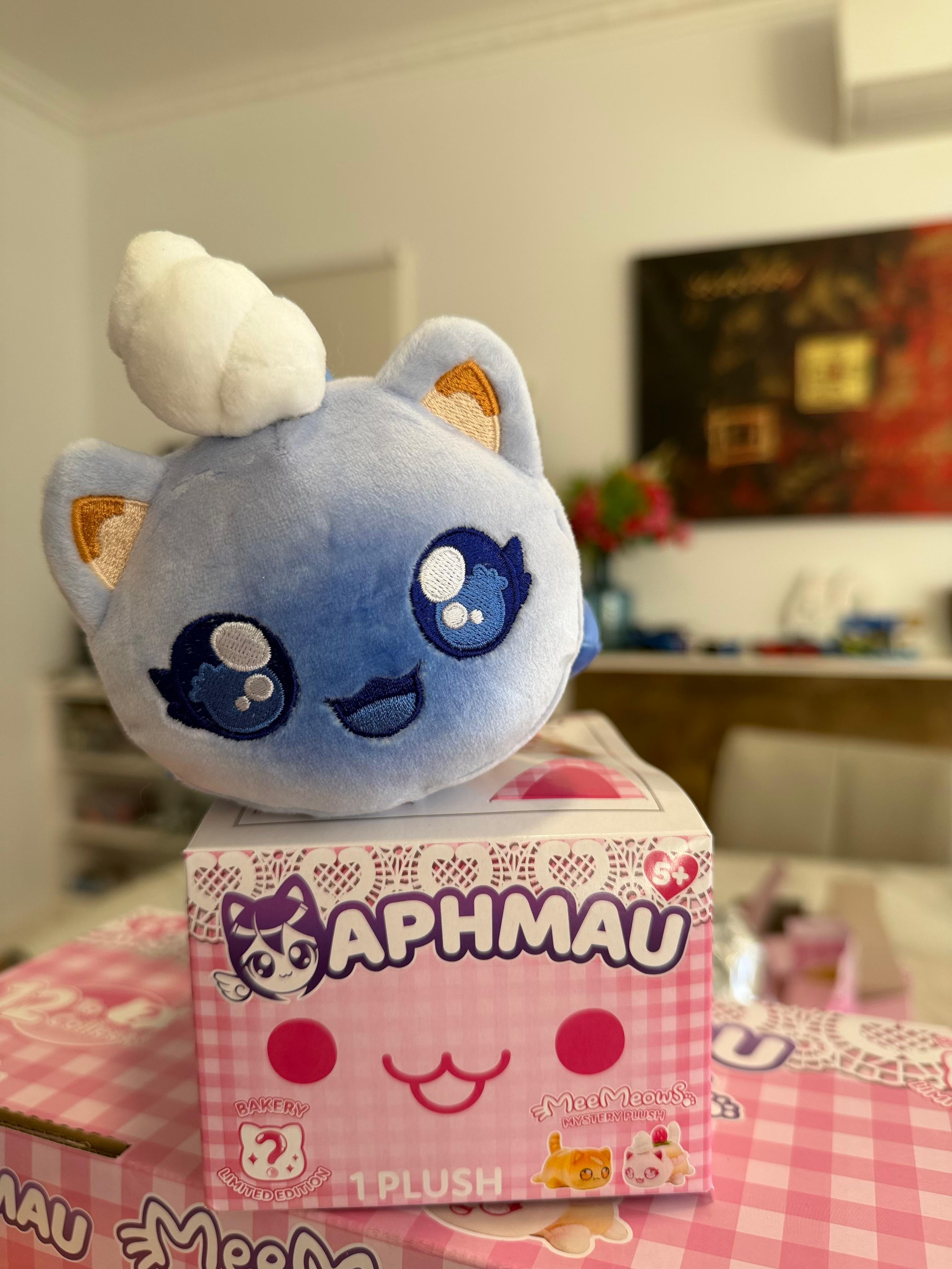 Aphmau MeeMeow Blueberry Muffin Plush sitting on Aphmau branded gift box