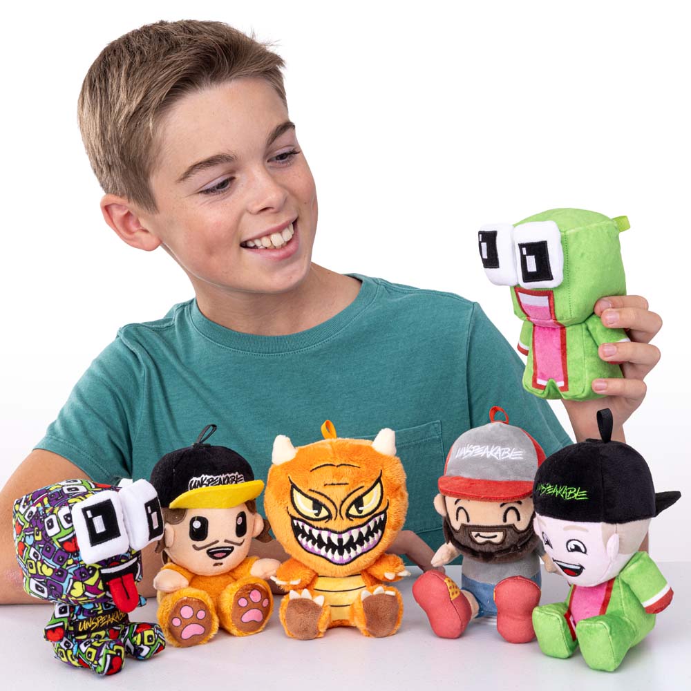 Boy holding Unspeakable mystery plush - Kaleidoscope Frog and Nathan