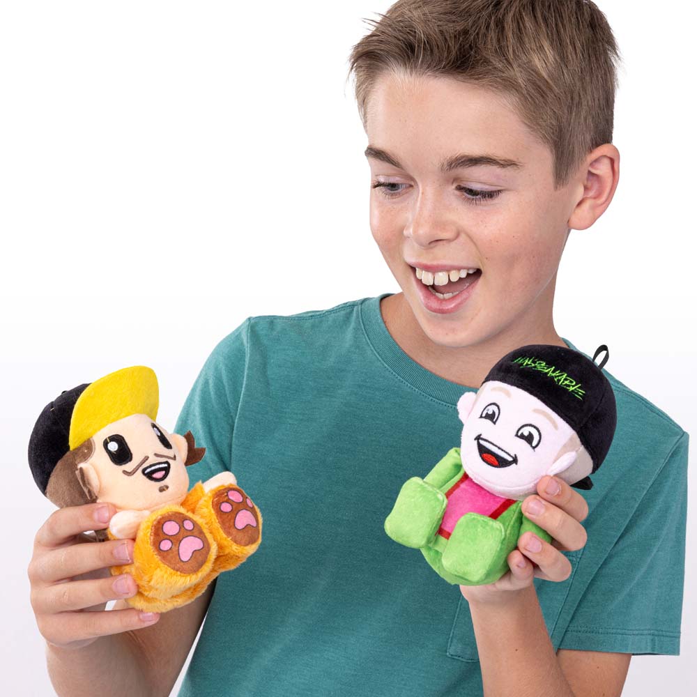 Boy holding Unspeakable mystery plush - Unspeakable and James characters