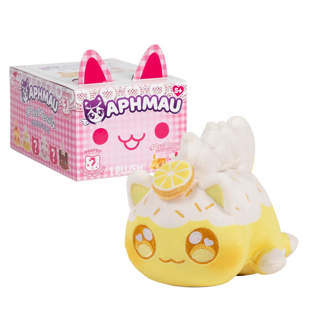 Aphmau Lemon Meringue Cat 6-inch yellow MeeMeows plush with white fluffy details beside pink Bakery Collection packaging.
