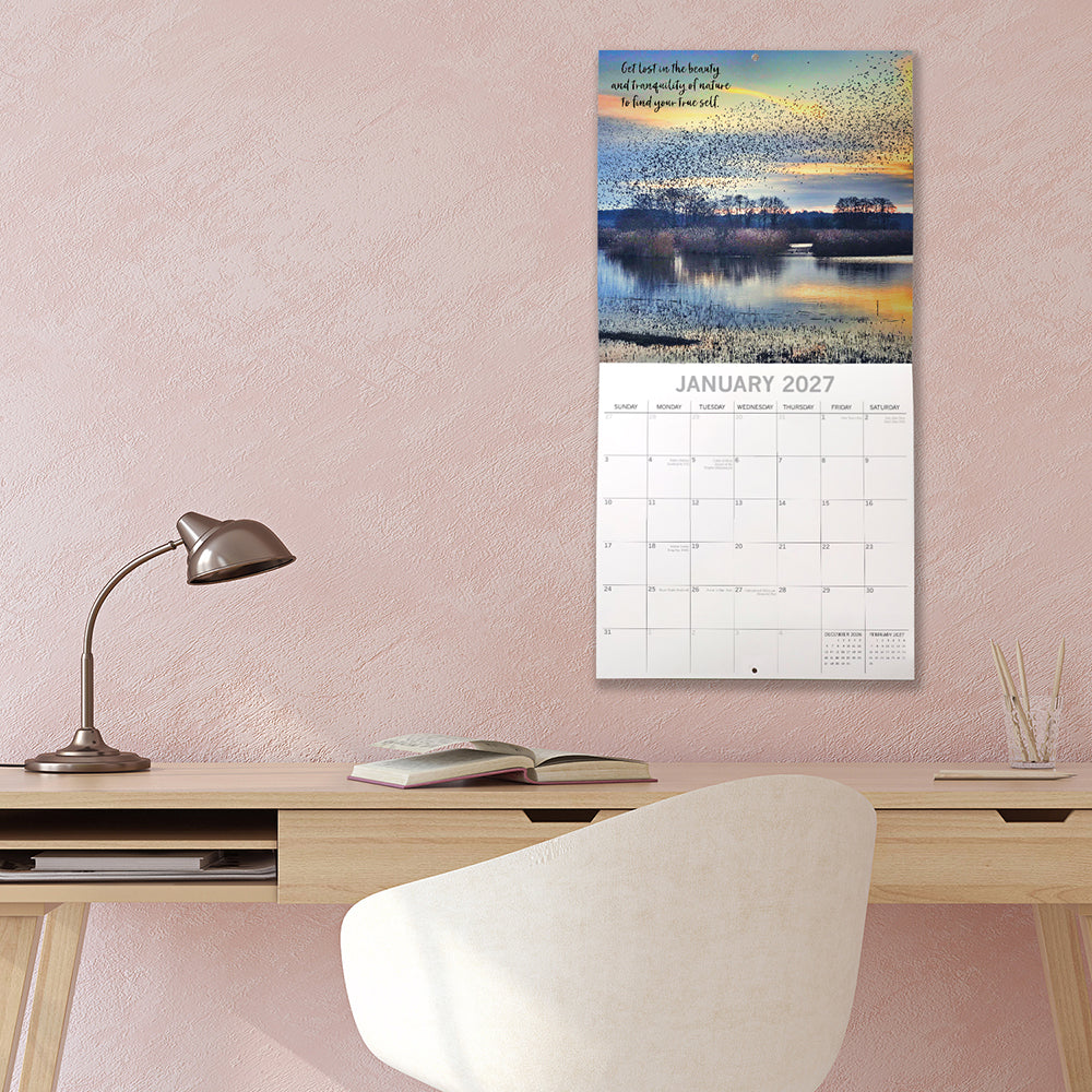 Tranquility 2027 Square Wall Calendar - January 2027 lifestyle shot hung on wall above a home office desk