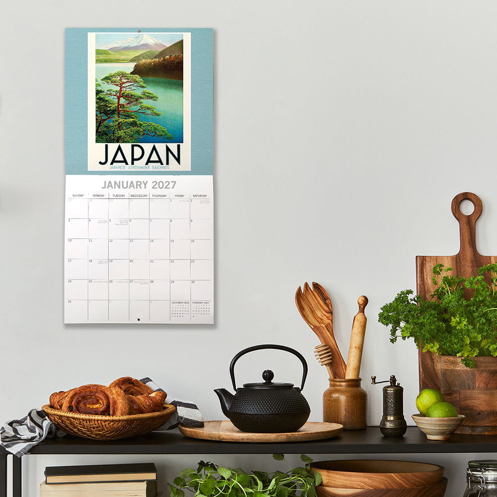 Vintage Travel Posters 2027 Calendar – January 2027 lifestyle shot on kitchen wall featuring Japan travel poster with Mount Fuji