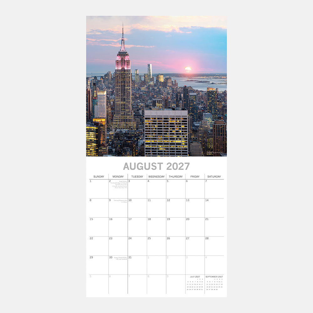 New York 2027 Calendar – August 2027 page featuring Empire State Building lit in pink at twilight rising above glowing Manhattan skyline at sunset