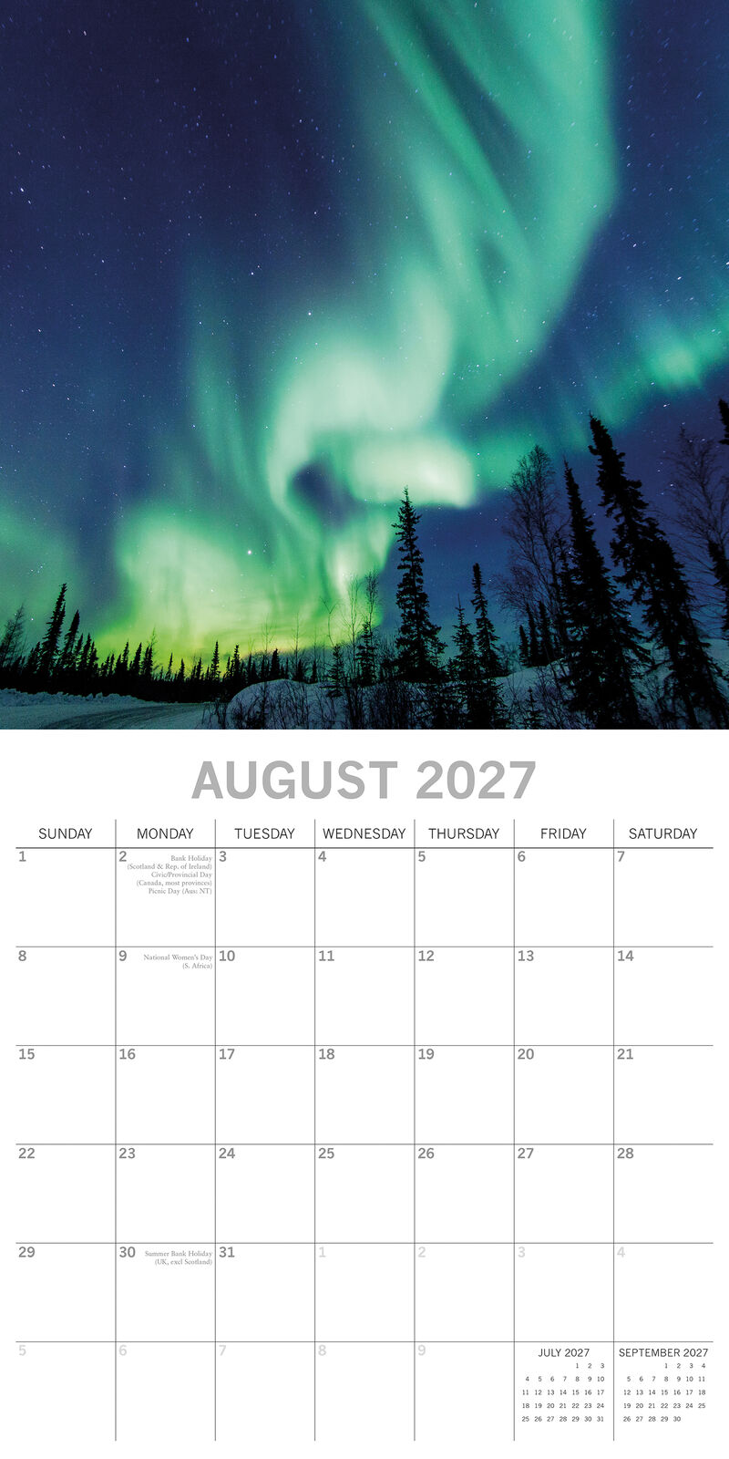 Northern Lights 2027 Calendar – January 2027 lifestyle shot on grey wall above desk featuring teal Aurora Borealis over snow-covered Norwegian mountains and fjord