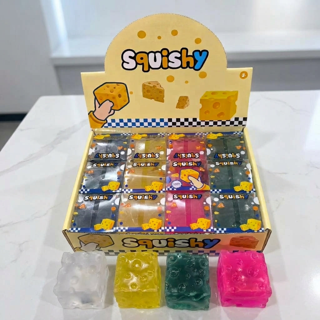 Yellow blue green and pink cheese cube squishies on retail boxes outdoors