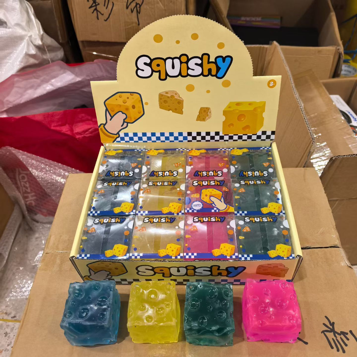 Promotional image showing four coloured cheese cube squishies