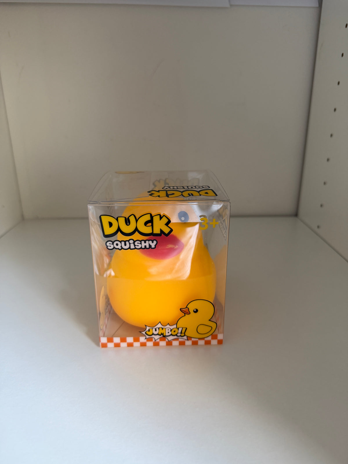 Front view of jumbo duck squishy in display packaging marked ages 3+
