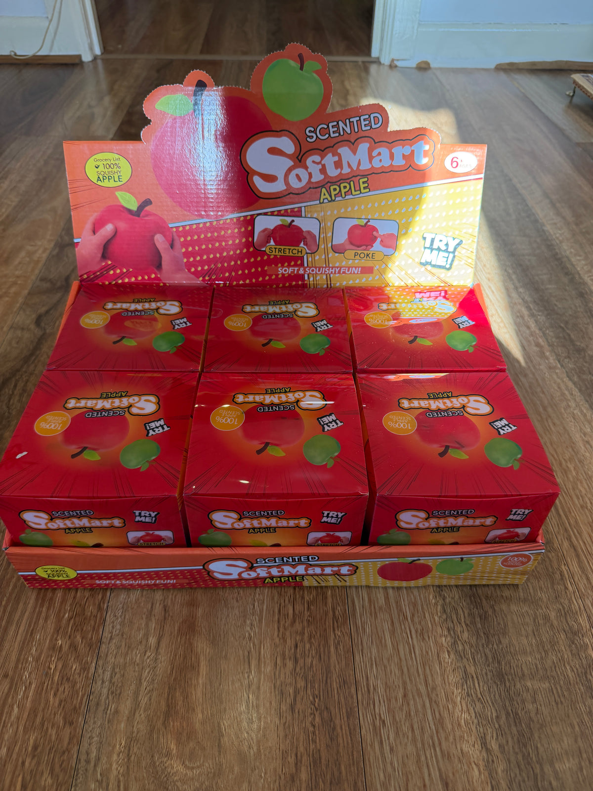 Softmart scented apple squishy retail boxes in a countertop display