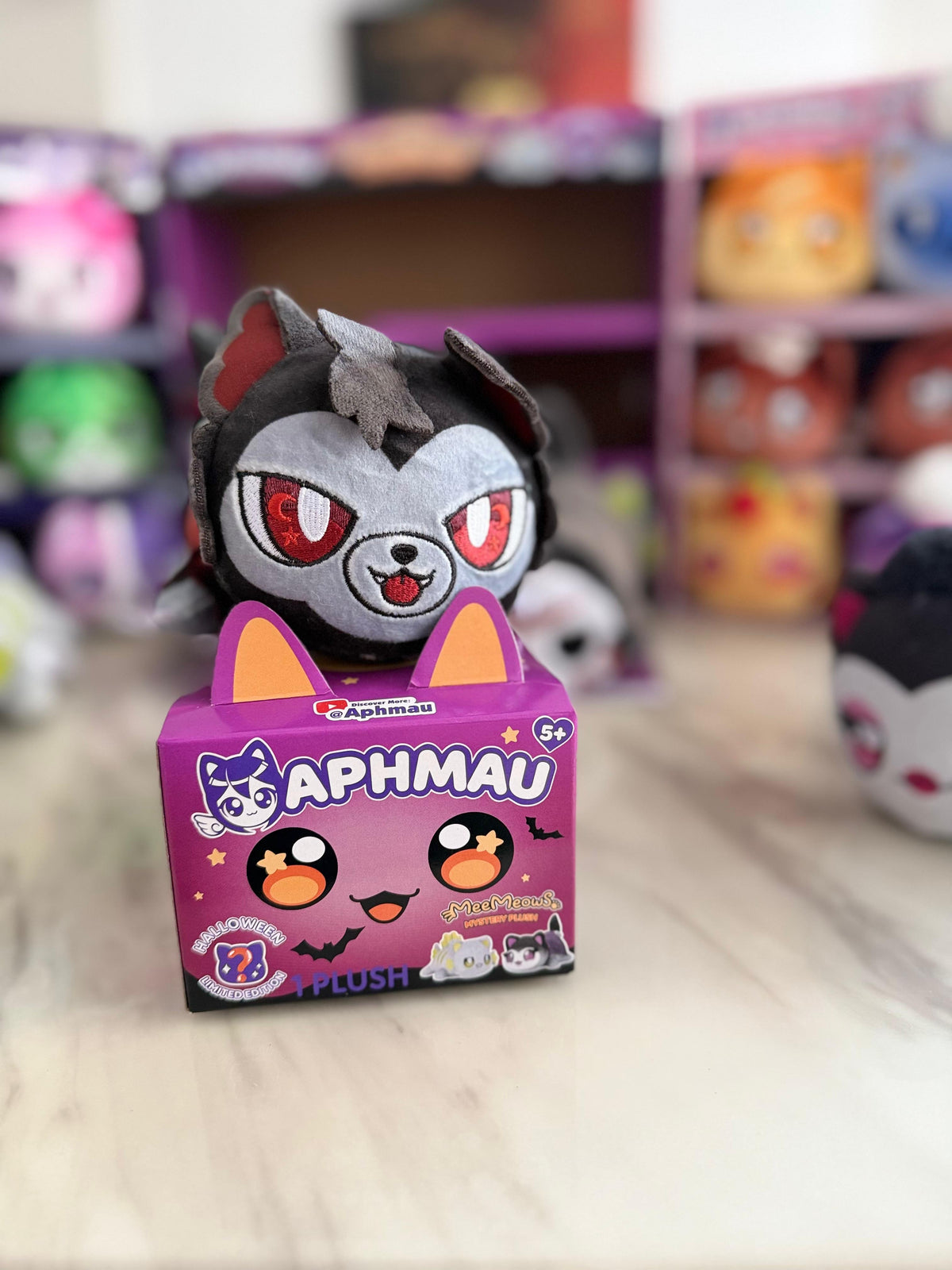 Aphmau Werewolf Cat Halloween plush displayed with its purple box