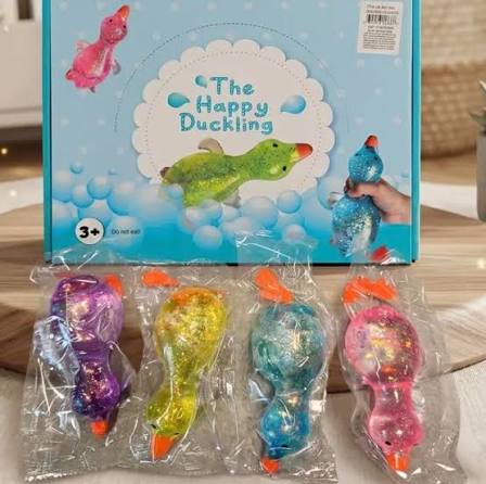 4 Happy Duckling glitter squeeze duck toys in purple, pink, blue and yellow individually wrapped