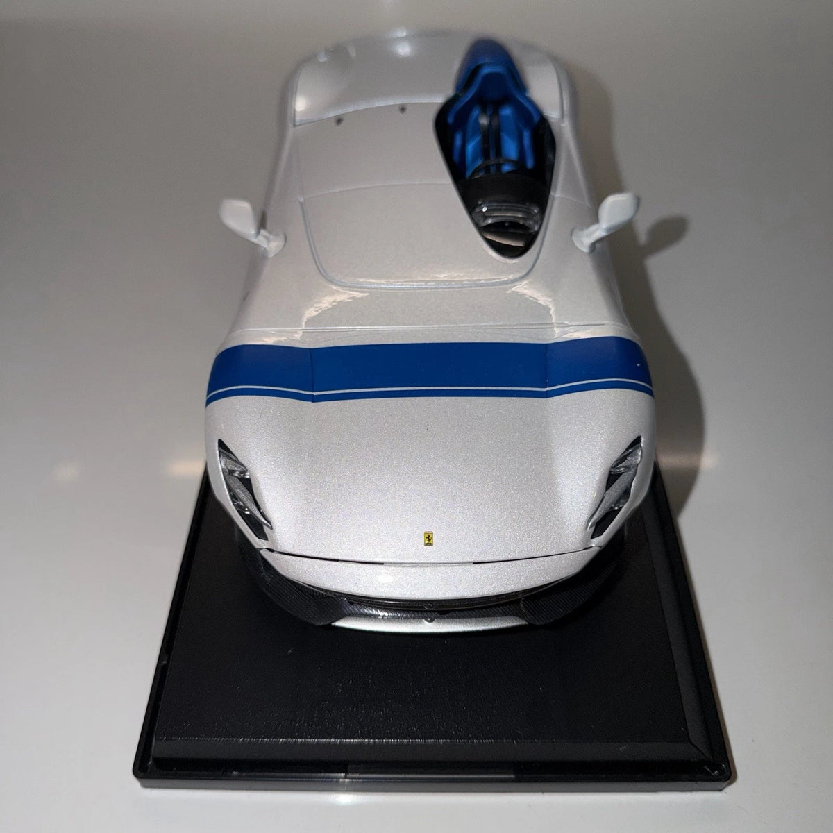 Maisto Ferrari Monza SP1 white 1/18 model car with blue accents on display base, front three-quarter view