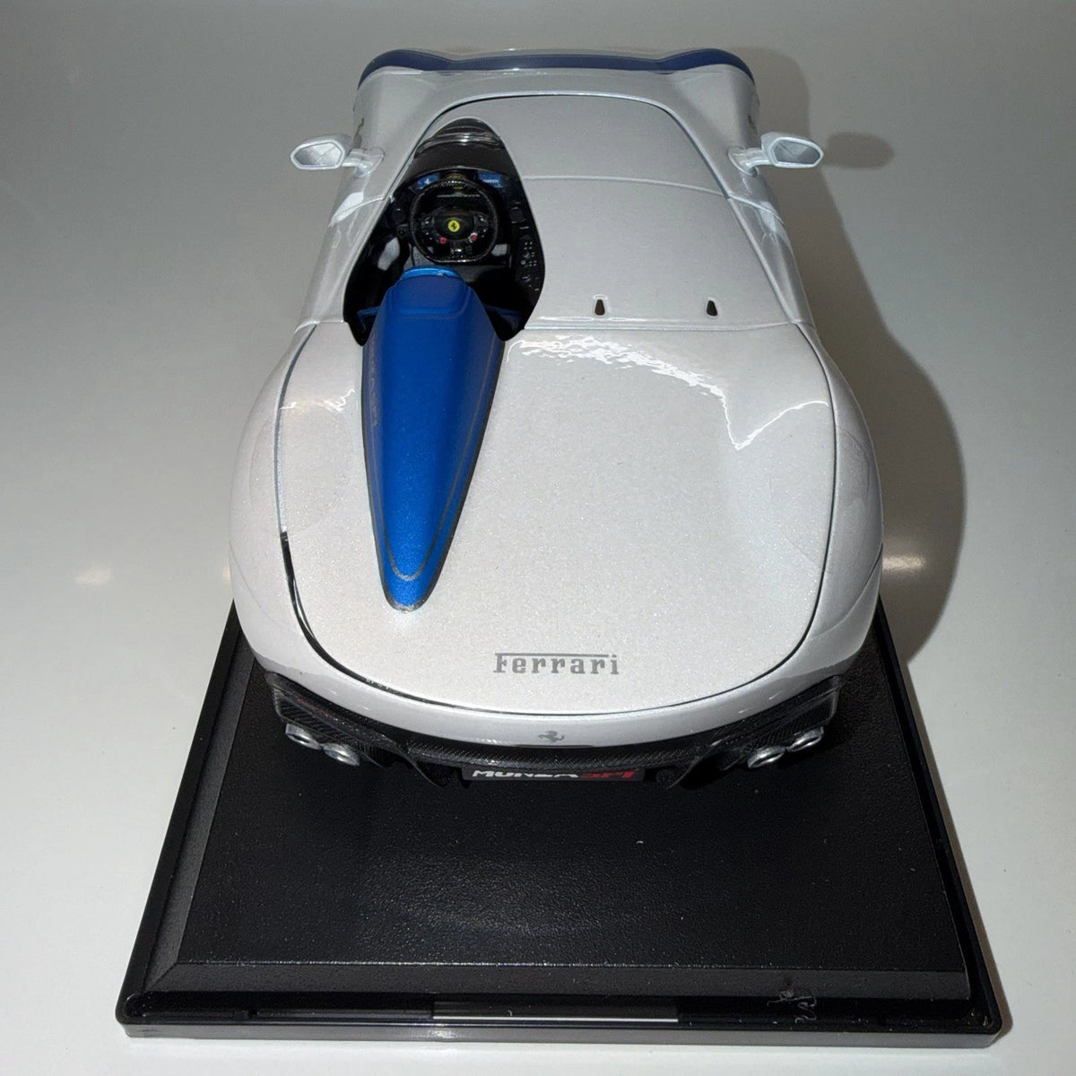 Rear overhead view of Maisto Ferrari Monza SP1 white model car showing blue single-seat cockpit