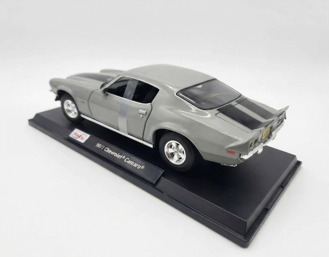 Rear three-quarter view of grey 1971 Chevrolet Camaro model showing black stripes and rear spoiler